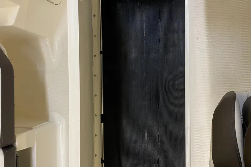 Slide: The Image of 2019 Sea Ray 190 SPX BR boat interior with black flooring and white seating. - 18