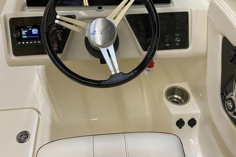 Slide: The Image of 2019 Sea Ray 190 SPX BR boat dashboard with steering wheel and controls. - 19