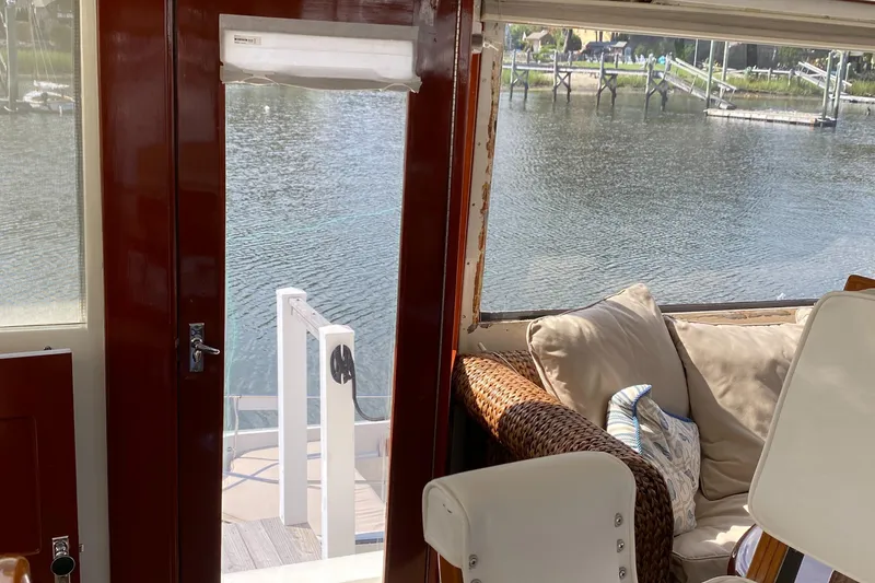 Slide: The Image of Interior view of 1973 Chris-Craft 47 Commander Flush Deck with water in the background. - 13