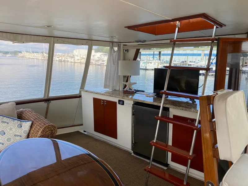 Slide: The Image of Interior of 1973 Chris-Craft 47 Commander Flush Deck yacht with marina view. - 21