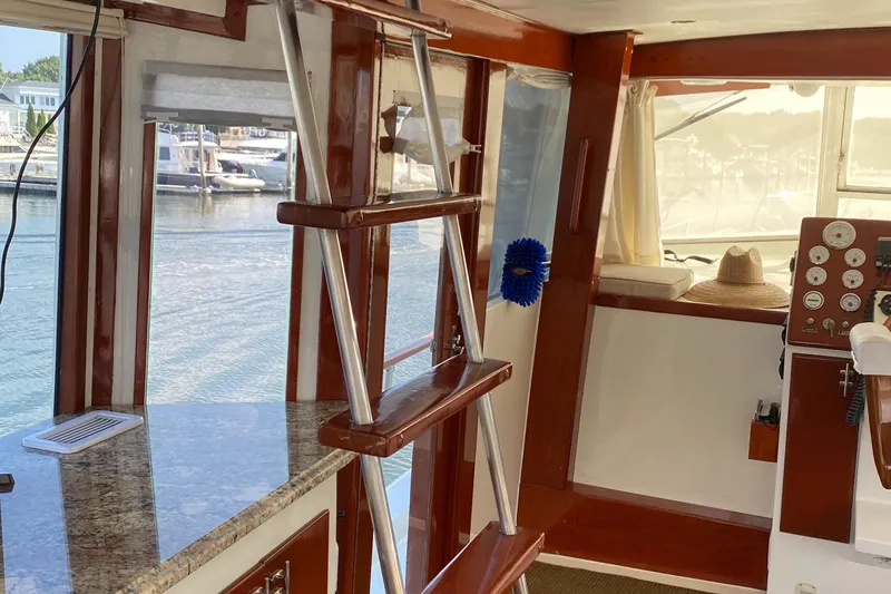 Slide: The Image of Interior of 1973 Chris-Craft 47 Commander Flush Deck with ladder and marina view. - 23