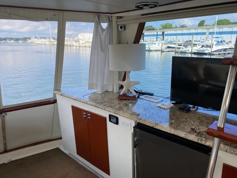 Slide: The Image of Interior of 1973 Chris-Craft 47 Commander Flush Deck with marina view. - 24