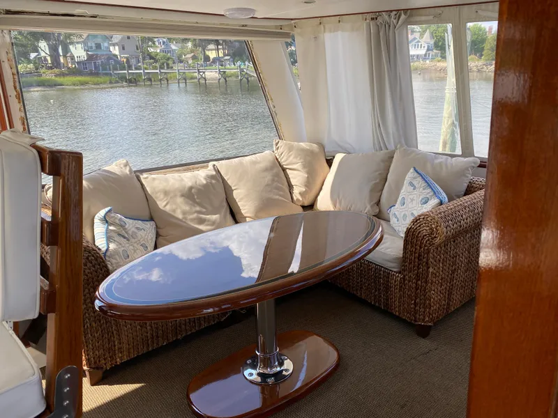 Slide: The Image of 1973 Chris-Craft 47 Commander Flush Deck interior with wicker sofa and polished table. - 25