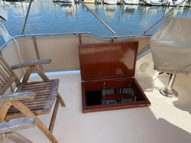 Slide: The Image of 1973 Chris-Craft 47 Commander Flush Deck with open hatch and wooden chairs on deck. - 30