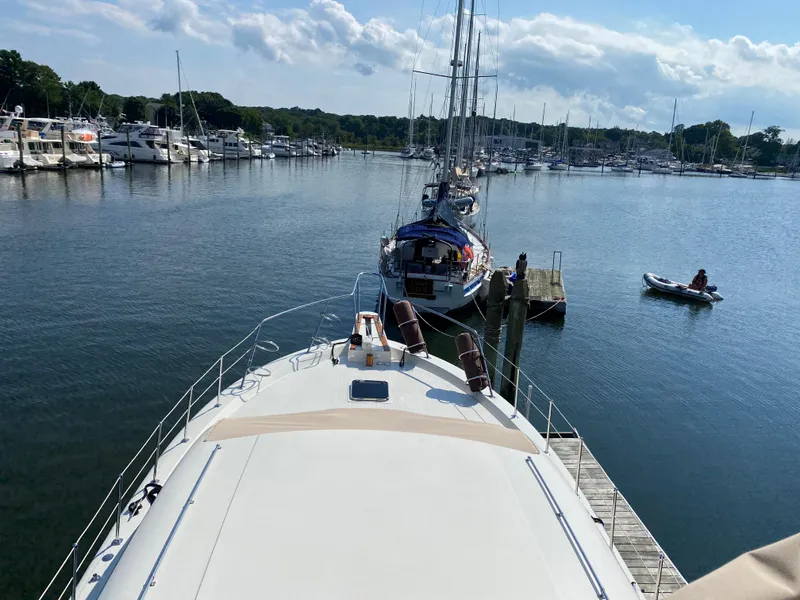 Slide: The Image of 1973 Chris-Craft 47 Commander Flush Deck yacht docked in a marina. - 34