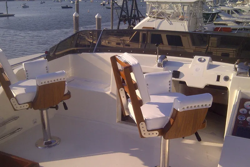 Slide: The Image of 1973 Chris-Craft 47 Commander Flush Deck yacht with white captain chairs and control panel. - 35