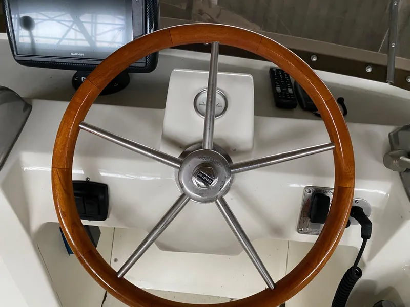 Slide: The Image of 1973 Chris-Craft 47 Commander Flush Deck helm with wooden steering wheel and navigation equipment. - 37