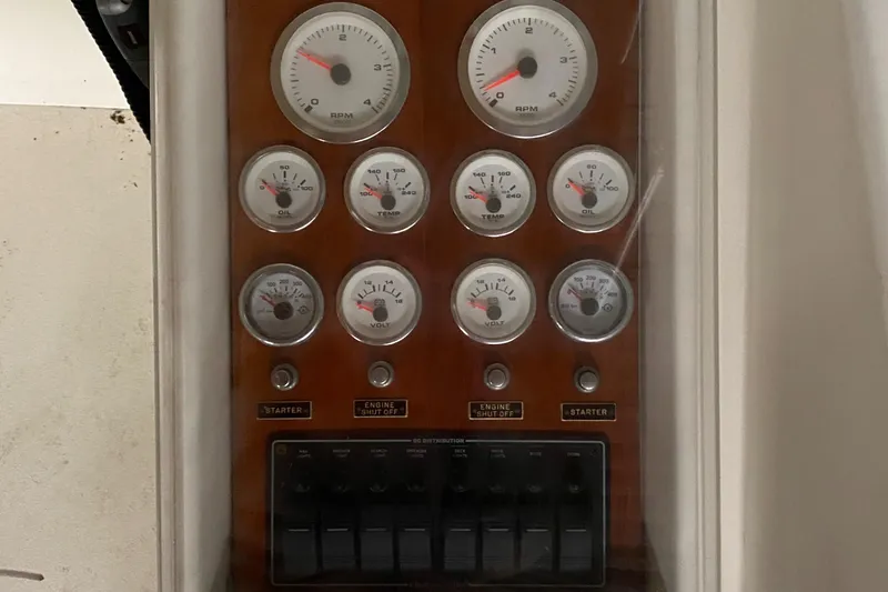 Slide: The Image of 1973 Chris-Craft 47 Commander Flush Deck control panel with gauges and switches. - 39