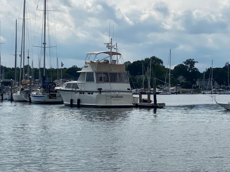 Slide: The Image of 1973 Chris-Craft 47 Commander Flush Deck yacht docked in a marina. - 4