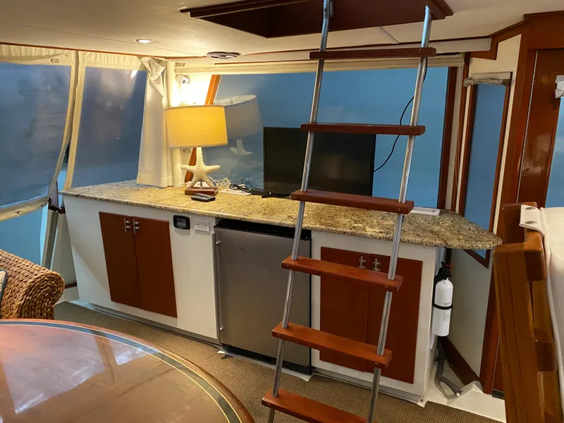 Slide: The Image of 1973 Chris-Craft 47 Commander Flush Deck interior with ladder, countertop, and lamp. - 44