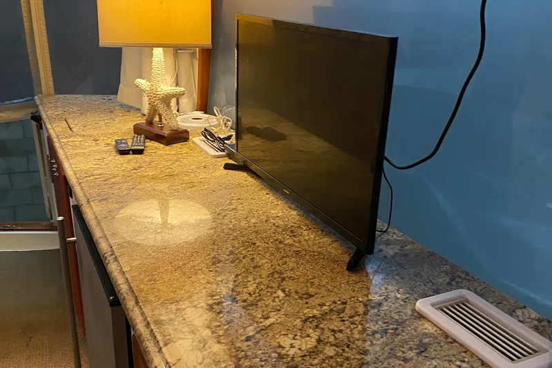 Slide: The Image of Granite countertop with TV and lamp inside 1973 Chris-Craft 47 Commander Flush Deck yacht. - 46