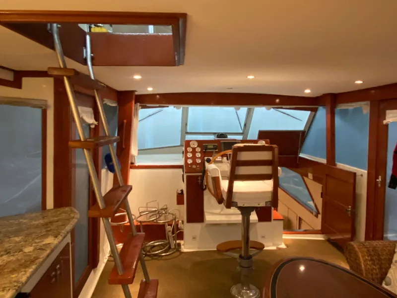 Slide: The Image of Interior of 1973 Chris-Craft 47 Commander Flush Deck with helm station and ladder. - 49