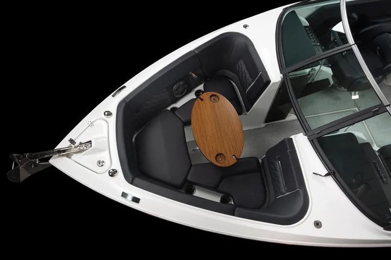Slide: The Image of 2023 Four Winns H2 OB boat interior with seating and wooden table. - 31