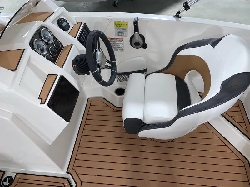 Slide: The Image of 2024 Starcraft SVX 191 boat interior with captain's chair and dashboard. - 6