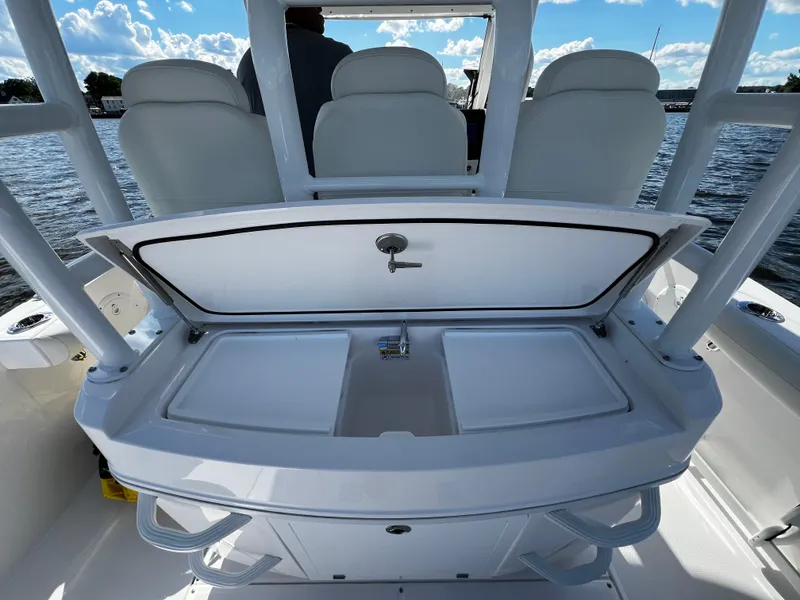 Slide: The Image of 2023 Everglades 335 Center Console boat with open storage compartment and seating. - 10