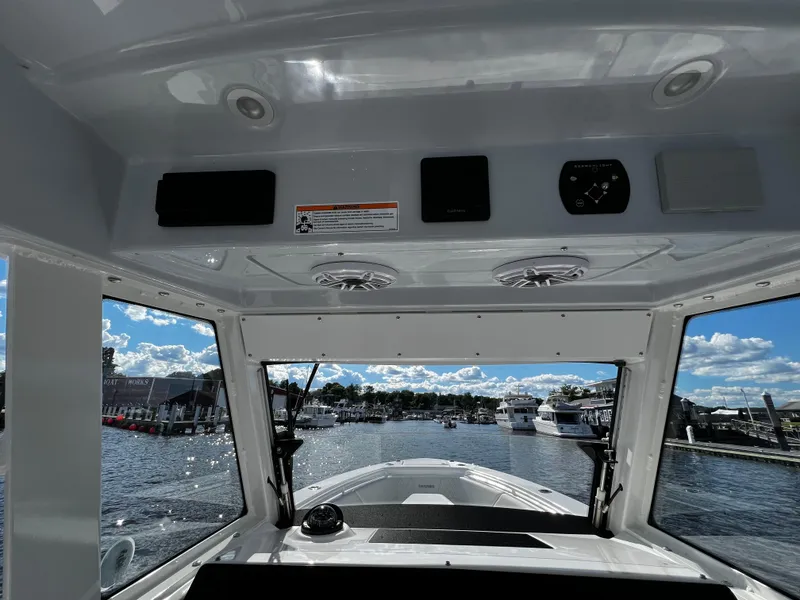 Slide: The Image of View from the helm of a 2023 Everglades 335 Center Console boat at a marina. - 15
