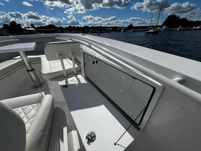 Slide: The Image of 2023 Everglades 335 Center Console boat interior with seating and storage. - 16