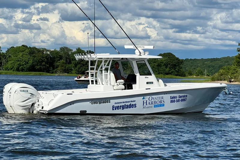 Slide: The Image of 2023 Everglades 335 Center Console boat on water with Yamaha engines. - 2