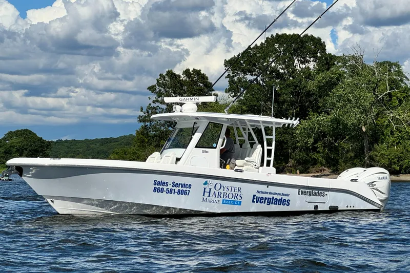 Slide: The Image of 2023 Everglades 335 Center Console boat on water with trees in background. - 5