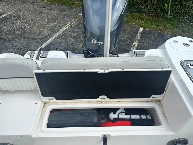 Slide: The Image of 2022 Sea Fox 248 Commander boat with open storage compartment and visible outboard motor. - 10