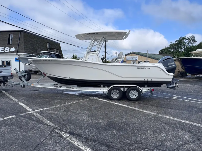 Slide: The Image of 2022 Sea Fox 248 Commander boat on trailer in parking lot. - 2