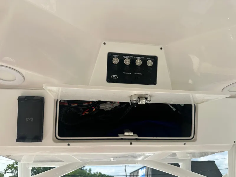 Slide: The Image of 2022 Sea Fox 248 Commander console with open storage compartment and control panel. - 23