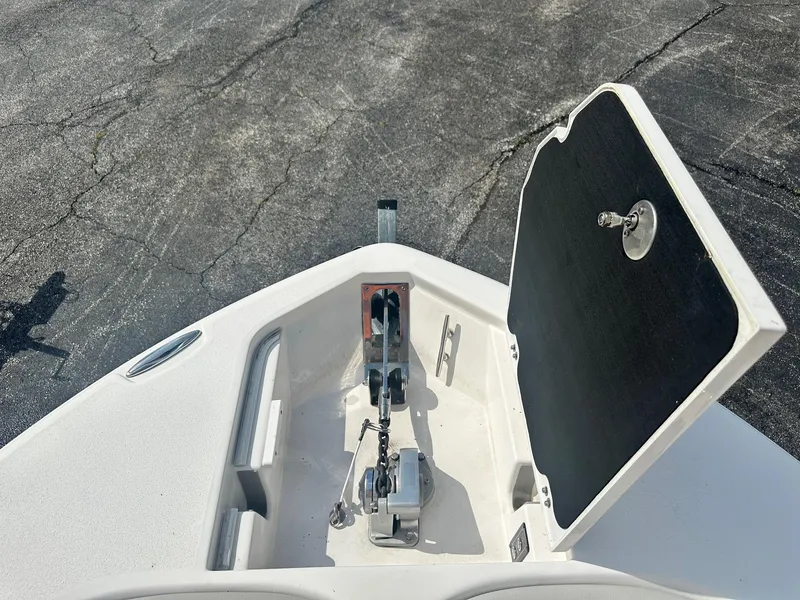 Slide: The Image of 2022 Sea Fox 248 Commander anchor compartment with open hatch on a textured surface. - 34