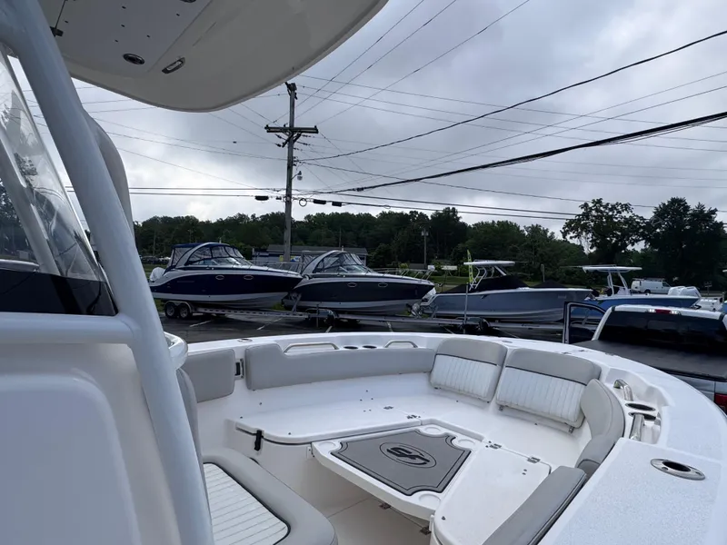 Slide: The Image of 2022 Sea Fox 248 Commander boat interior with seating, parked outdoors. - 37