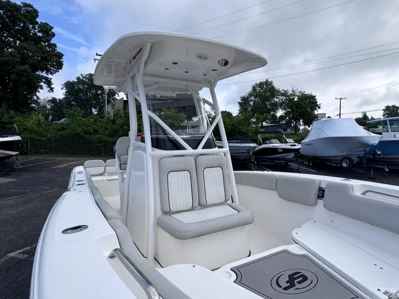 Slide: The Image of 2022 Sea Fox 248 Commander boat with center console and seating, parked outdoors. - 38
