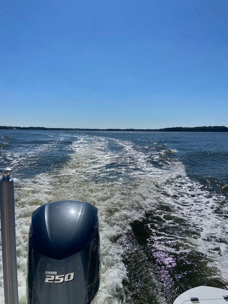 Slide: The Image of Sea Fox 248 Commander 2022 boat cruising on open water under clear blue sky. - 9