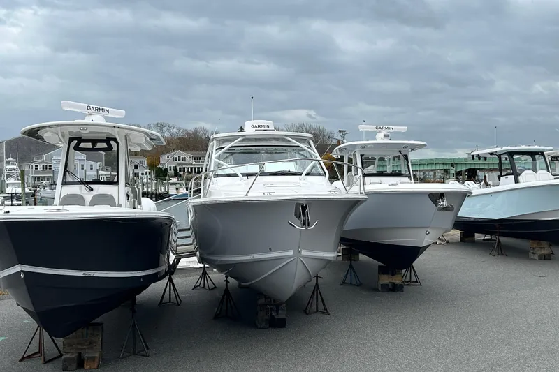 Slide: The Image of 2024 Albemarle 30 Express boats displayed at a marina under cloudy skies. - 10