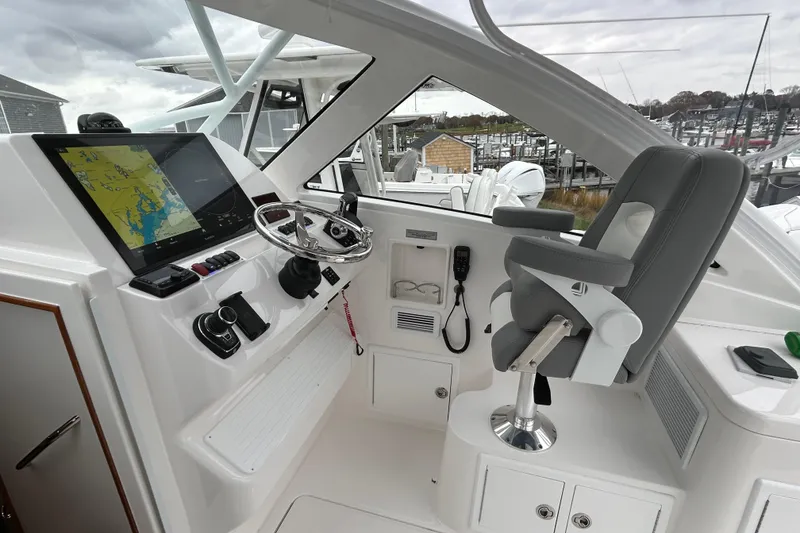 Slide: The Image of 2024 Albemarle 30 Express helm with navigation display and captain's chair. - 21