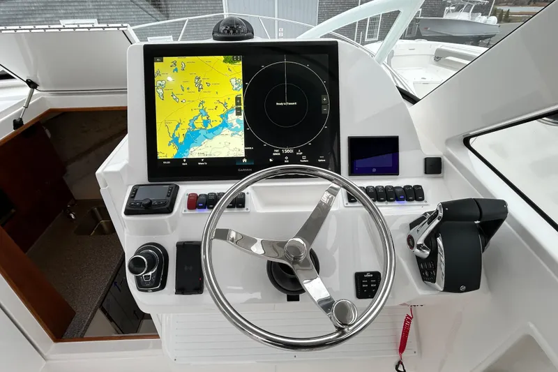 Slide: The Image of 2024 Albemarle 30 Express helm with navigation display and steering wheel. - 22