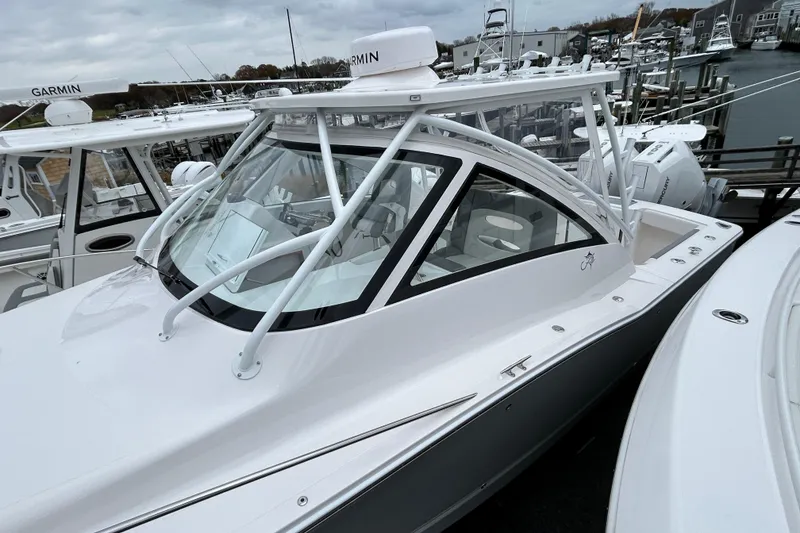 Slide: The Image of 2024 Albemarle 30 Express boat docked, featuring sleek design and advanced Garmin navigation. - 28