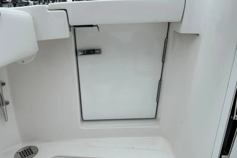 Slide: The Image of 2024 Albemarle 30 Express boat interior with white storage compartment door. - 32