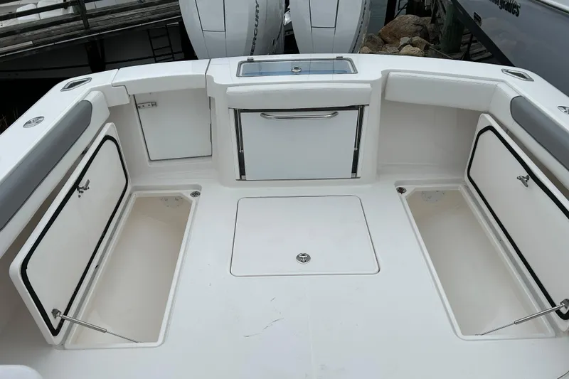 Slide: The Image of 2024 Albemarle 30 Express boat deck with storage compartments and seating. - 34