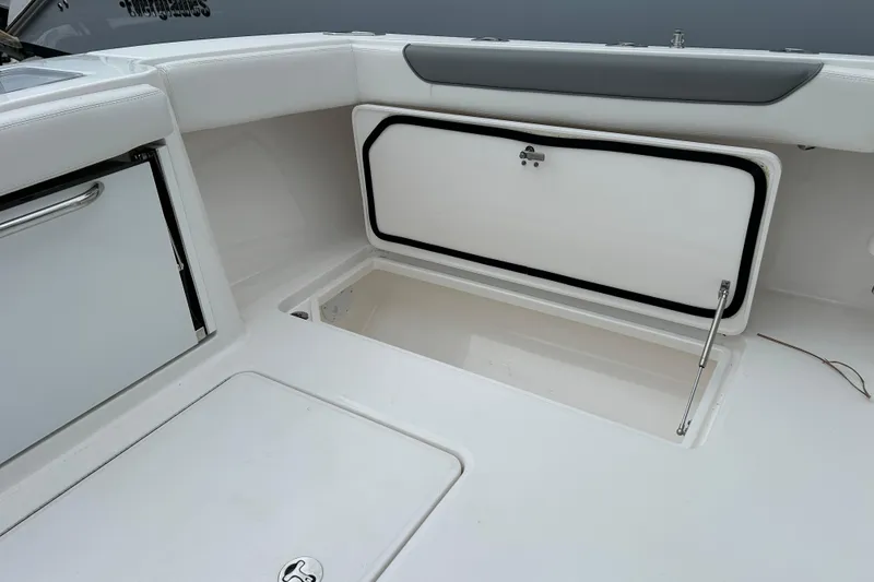 Slide: The Image of 2024 Albemarle 30 Express boat interior storage compartment, featuring sleek white design. - 35