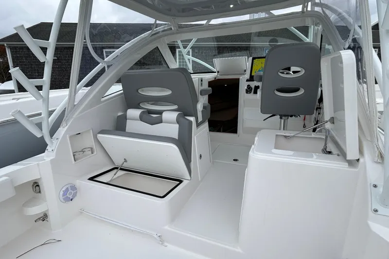 Slide: The Image of 2024 Albemarle 30 Express boat interior with seating, storage, and helm station. - 37