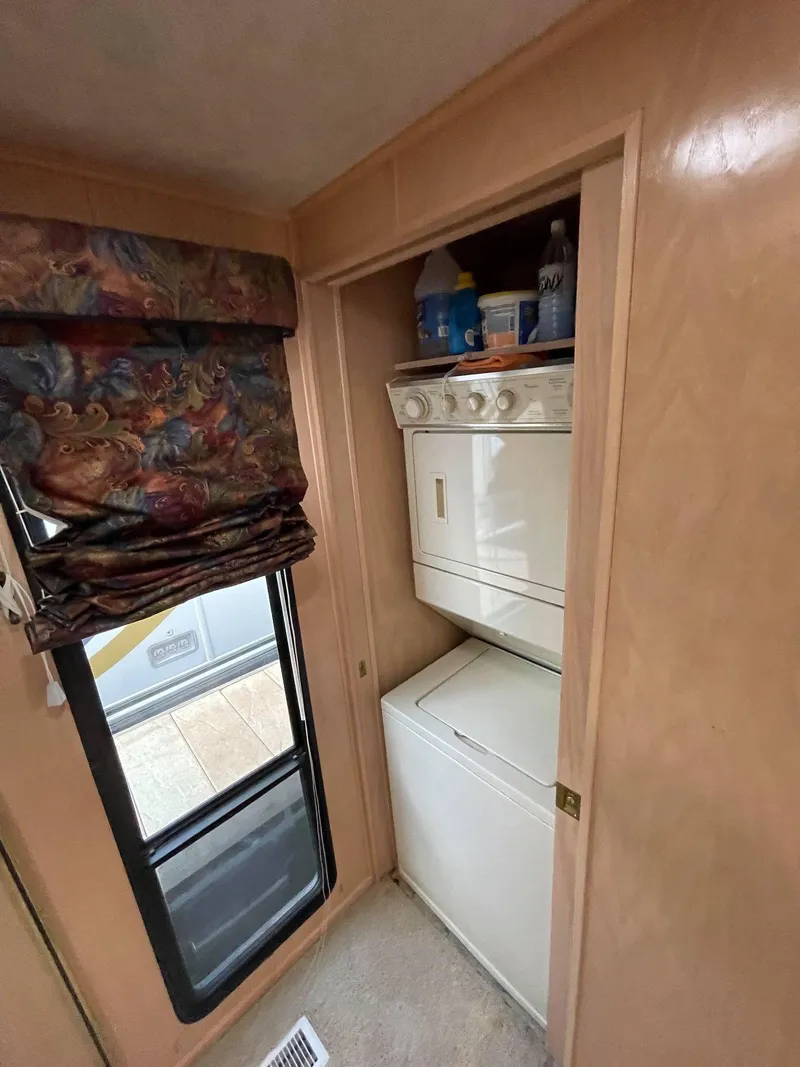 Slide: The Image of Laundry area in 1998 Sumerset 86' by 18' houseboat with stacked washer and dryer. - 11