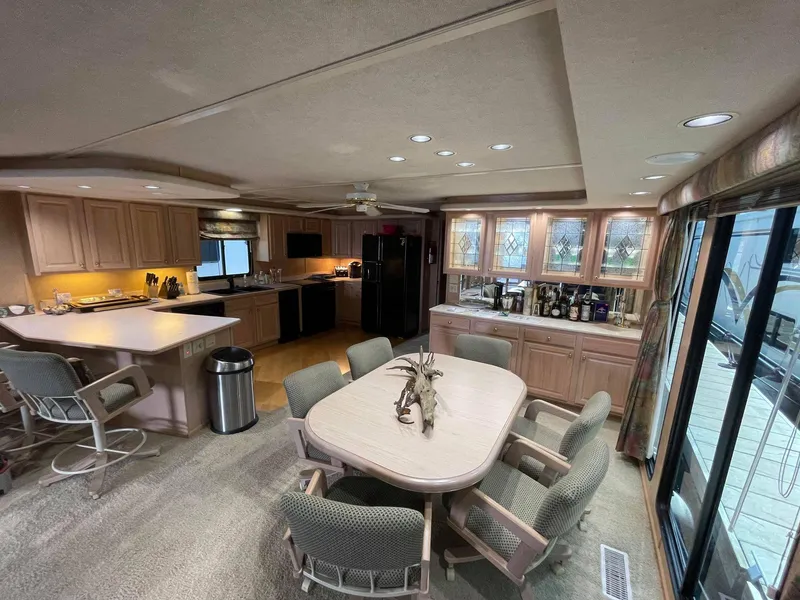 Slide: The Image of Spacious interior of a 1998 Sumerset 86' by 18' houseboat with kitchen and dining area. - 12