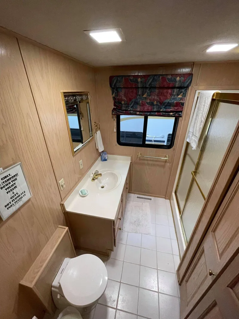 Slide: The Image of 1998 Sumerset 86' by 18' houseboat bathroom with shower, sink, and toilet. - 13