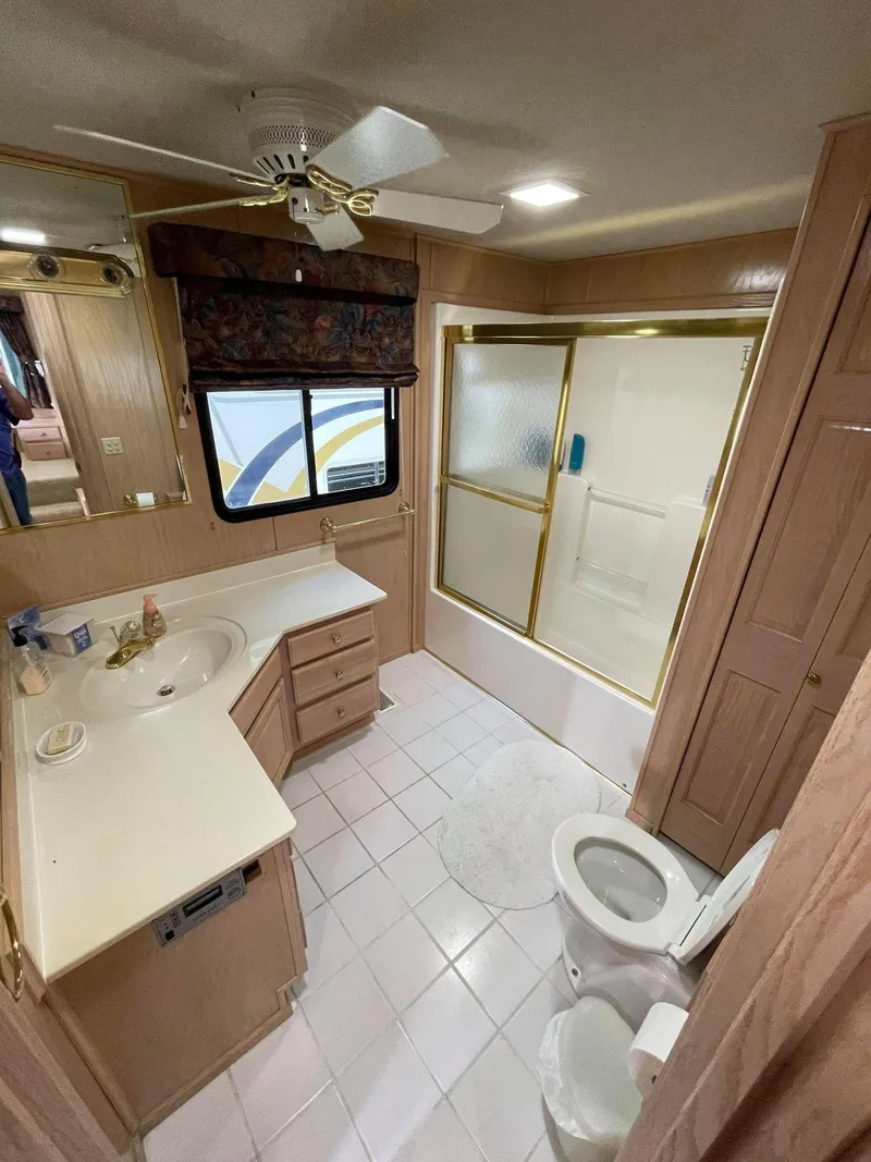 Slide: The Image of 1998 Sumerset 86' by 18' houseboat bathroom with shower, toilet, and vanity. - 17