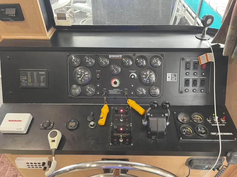 Slide: The Image of Control panel of a 1998 Sumerset 86' by 18' houseboat with various gauges and controls. - 5