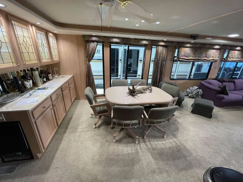 Slide: The Image of Spacious interior of a 1998 Sumerset 86' by 18' houseboat with dining area and lounge. - 8