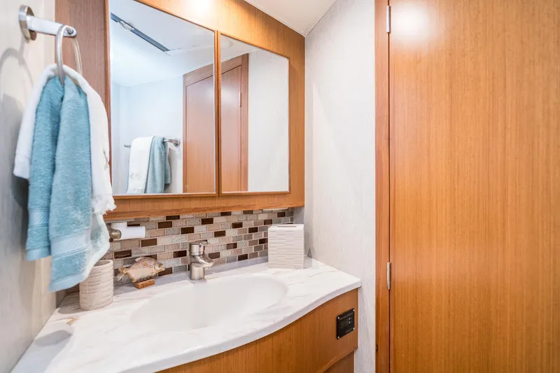Slide: The Image of Modern bathroom in 2025 Henriques 50 Sportfisherman yacht with wood accents and marble countertop. - 13