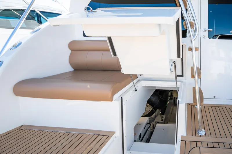 Slide: The Image of 2025 Henriques 50 Sportfisherman boat with tan seating and engine compartment. - 16