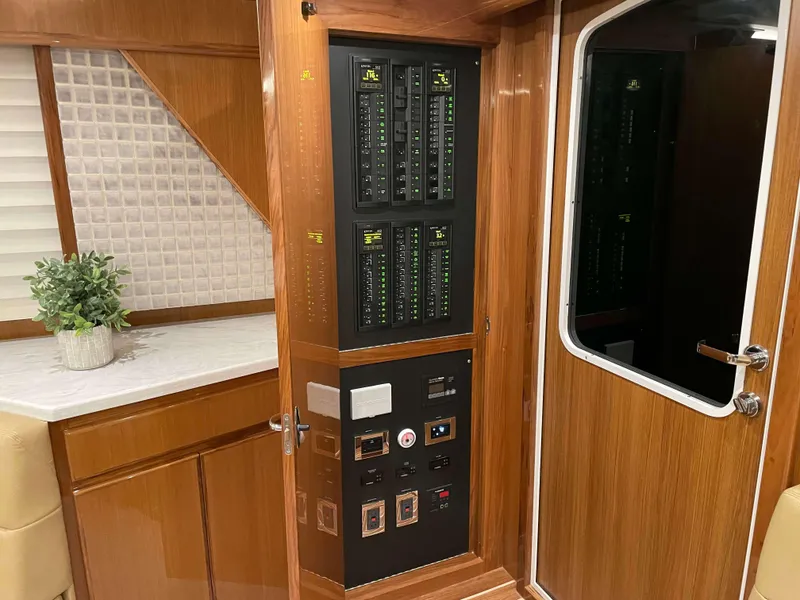 Slide: The Image of Electrical panel inside 2025 Henriques 50 Sportfisherman yacht with wooden cabinetry. - 26