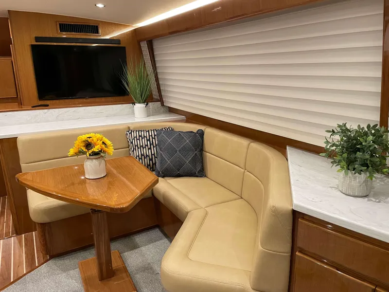 Slide: The Image of Interior of 2025 Henriques 50 Sportfisherman with cozy seating, table, and decor. - 27