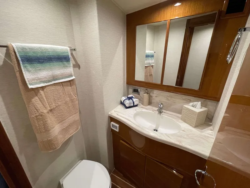 Slide: The Image of Modern bathroom in 2025 Henriques 50 Sportfisherman yacht with sink, mirror, and towel. - 32