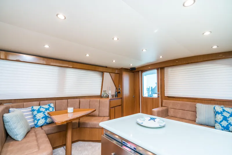 Slide: The Image of 2025 Henriques 50 Sportfisherman interior with cozy seating and modern decor. - 9